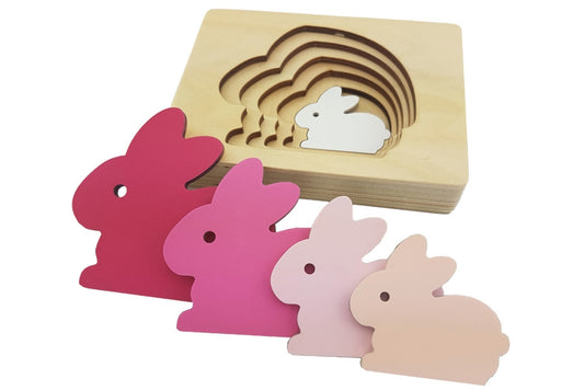 Five-layered rabbit puzzle. Each layer is a progressively larger rabbit in a darker pink.