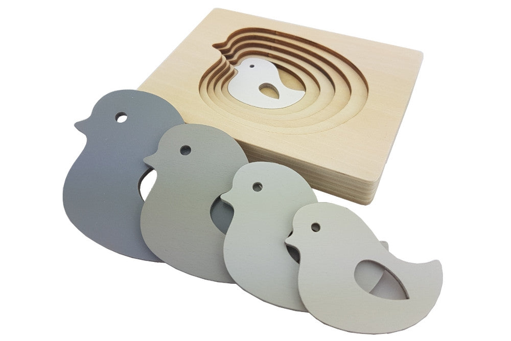 Five-layered bird puzzle. Each layer is a progressively larger bird in a darker grey.