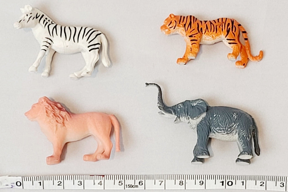 Zebra, tiger, lion, and elephant laid beside a measuring tape. Lengths are around 5 cm.