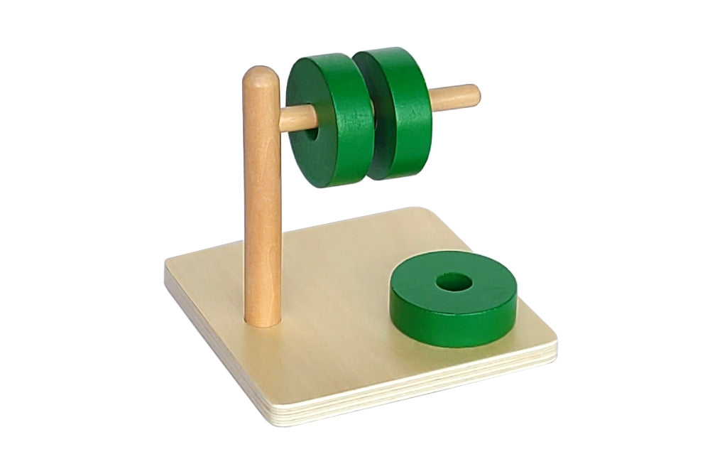 Two green discs on a wooden horizontal dowel. Dowel attached to a wooden base, upon which rests a third green disc.