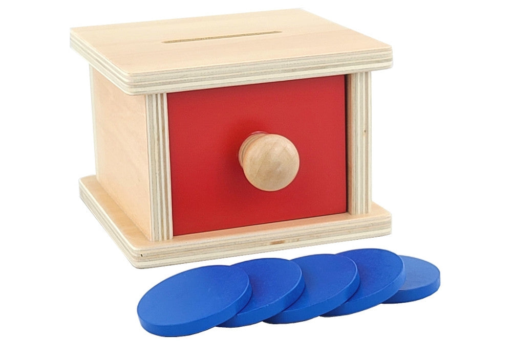 Wooden coin box with red drawer and five blue coins. Box has slot at top for inserting coins.