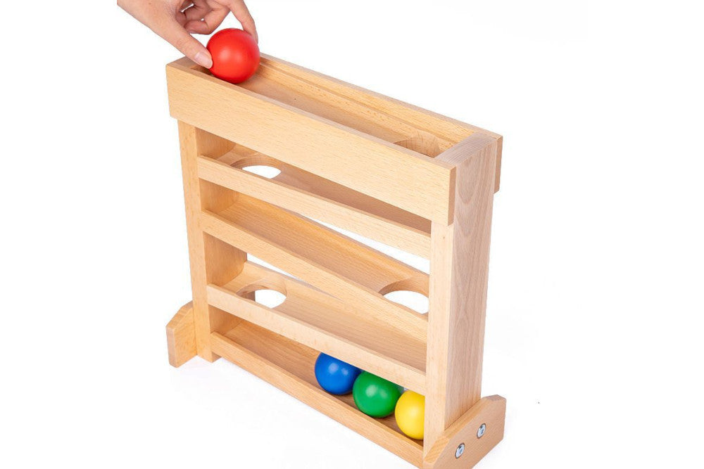 A hand placing the red ball at the top of the ball tracker.
