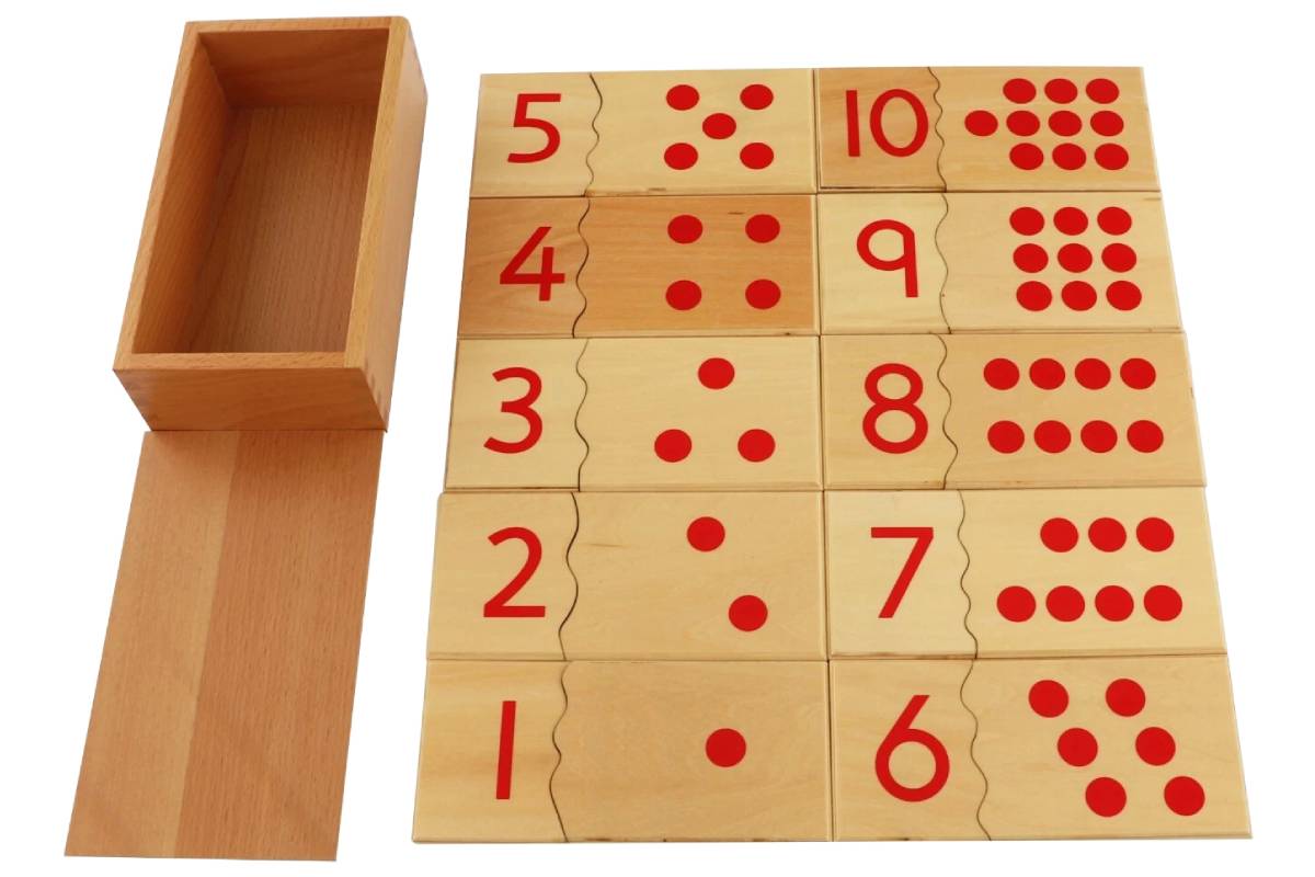 All ten pairs of wooden cards 1-10 laid out beside the open box. Each pair has the number on the left piece, and the corresponding number of red dots on the right.