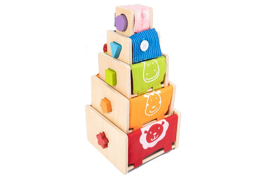 Five colourful wood-and-fabric busy cubes stacked upon one another from largest to smallest. The colours form a partial rainbow: red, orange, green, blue, and purple. Each box has a shape cut into its side with a matching wooden block that fits through.