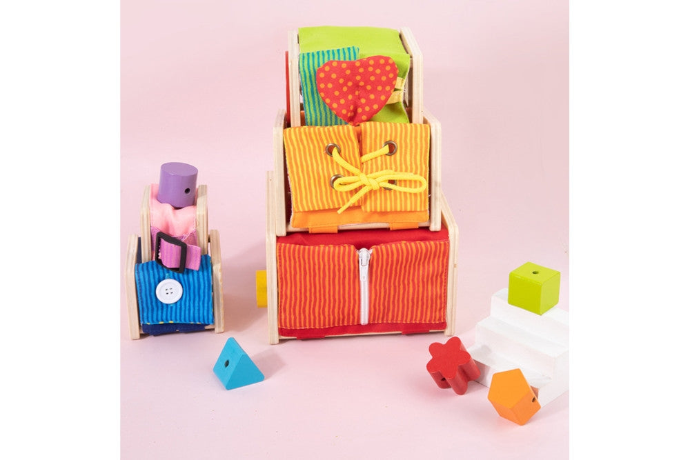 Another side of the cubes showing activities such as a zipper, laces, loop, button, and buckle. The wooden shape blocks have holes and can be threaded.