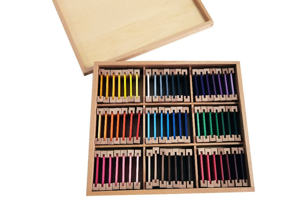 Third colour tablet box with nine compartments. Each compartment contains seven tablets of different shades of a colour: yellow, grey, purple, orange, blue, green, pink, brown, and red. The lid is beneath the box.