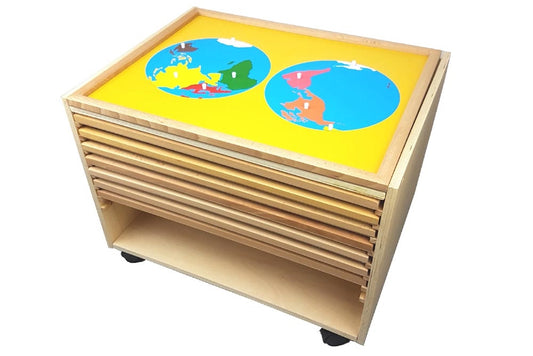 A rolling wooden cabinet containing eight puzzle maps. The map on top is the Puzzle Map of World Parts.