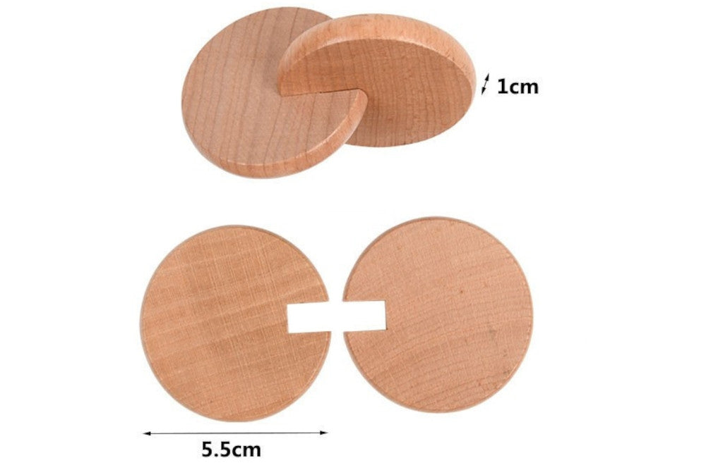 A pair of interlocking discs that separate. Each disc is 1 cm thick and 5.5 cm in diameter.