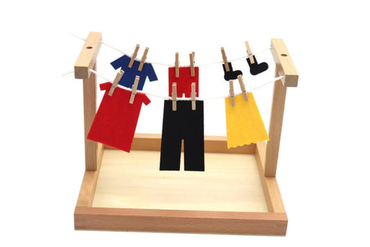 Assembled clothesline activity with two parallel clotheslines on a wooden base. Hanging on them are several articles of clothing.