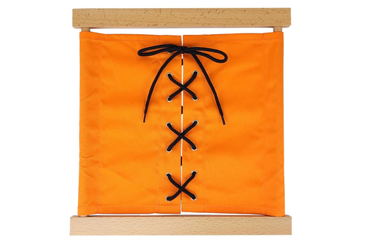 Wooden lacing dressing frame with orange fabric and black laces.