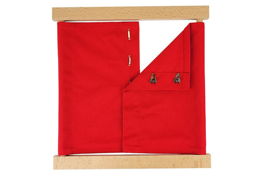 Wooden hook & eye dressing frame with red fabric.