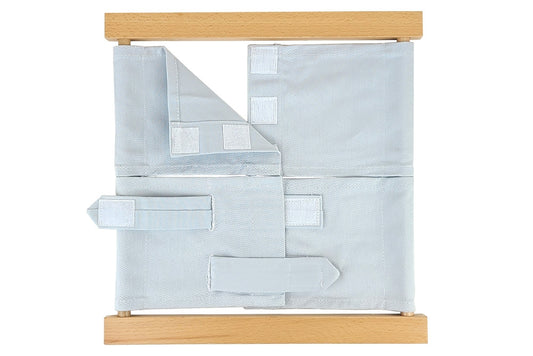 Wooden velcro dressing frame with grey fabric and white velcro.